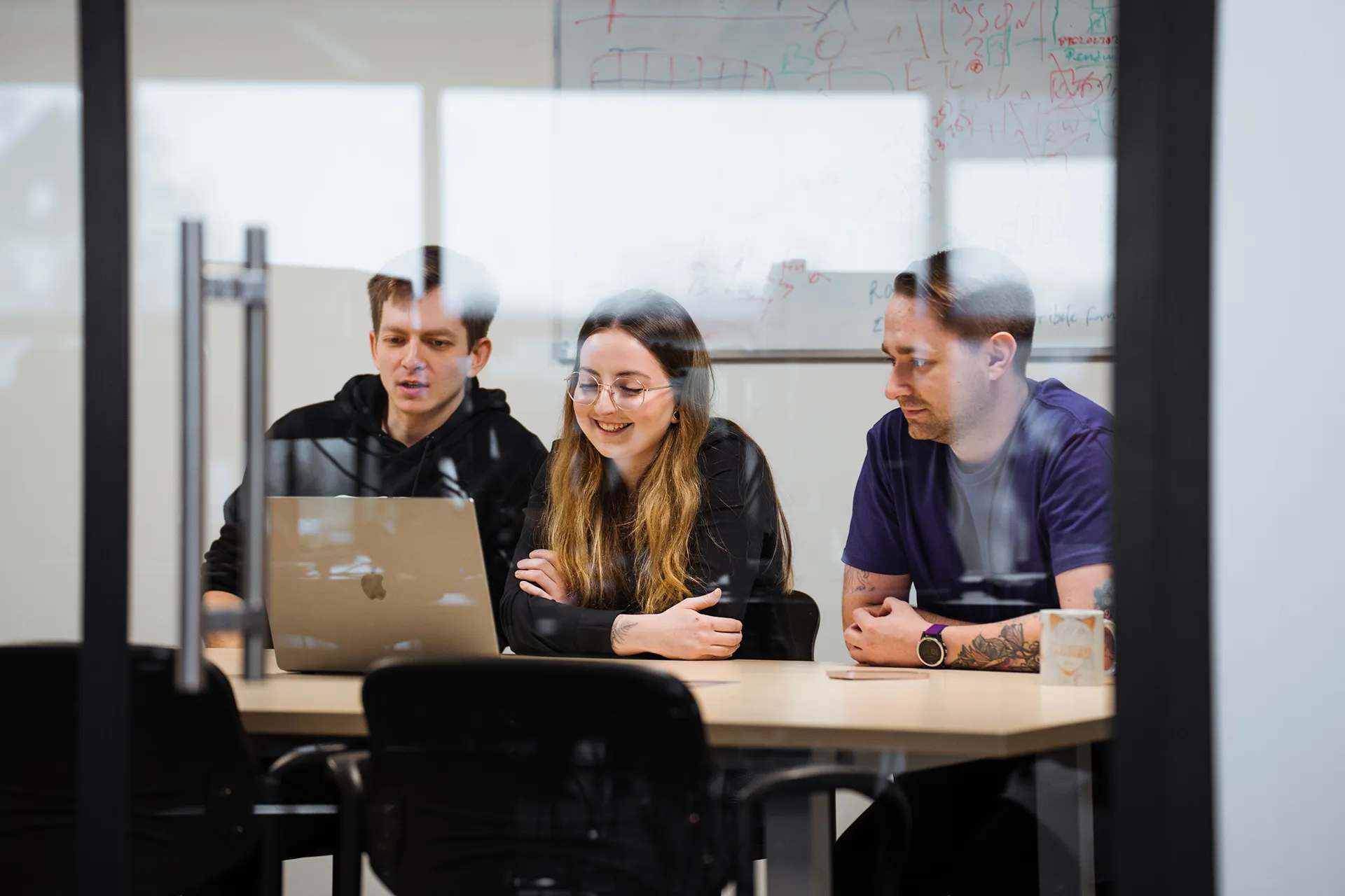 A group of three individuals seated at a table.