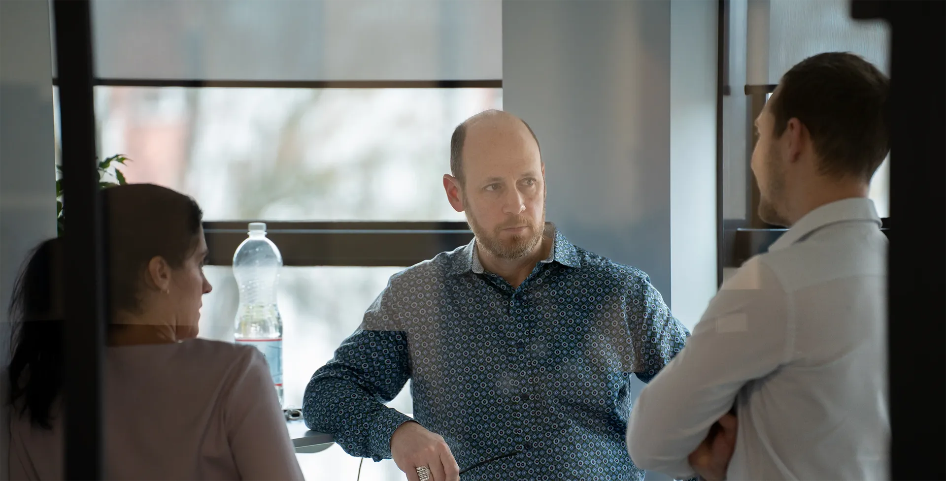 Three people are having a serious conversation.